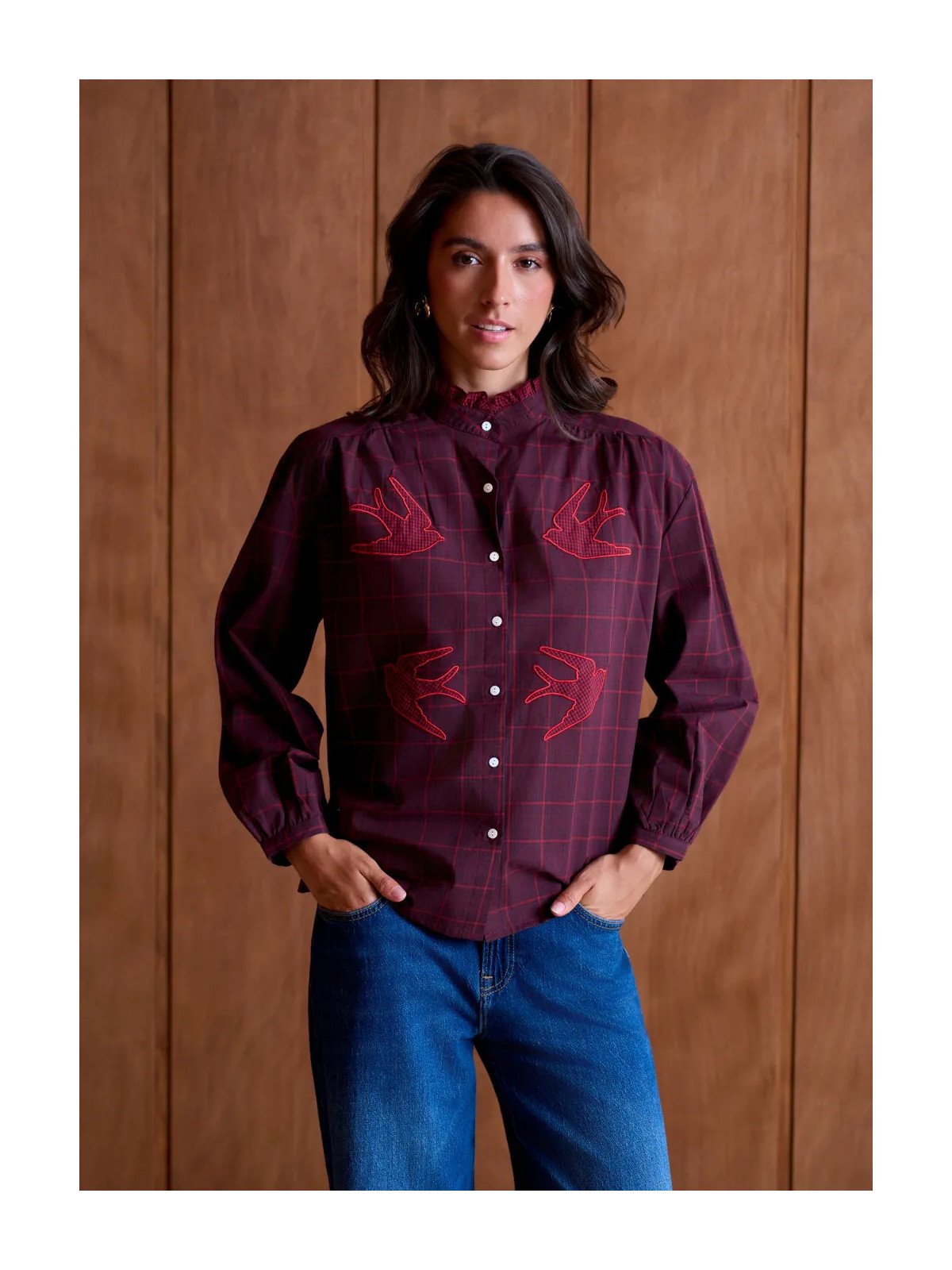 Women's loose-fitting blouse with a gathered neckline and appliqué details