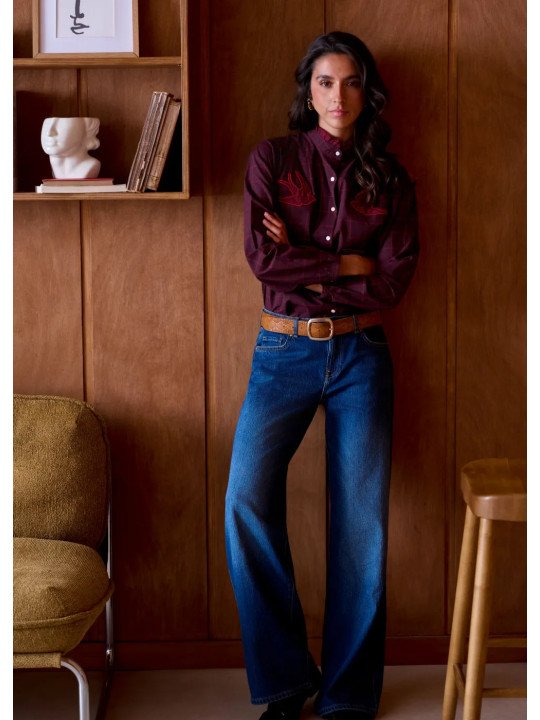 Women's loose-fitting blouse with a gathered neckline and appliqué details