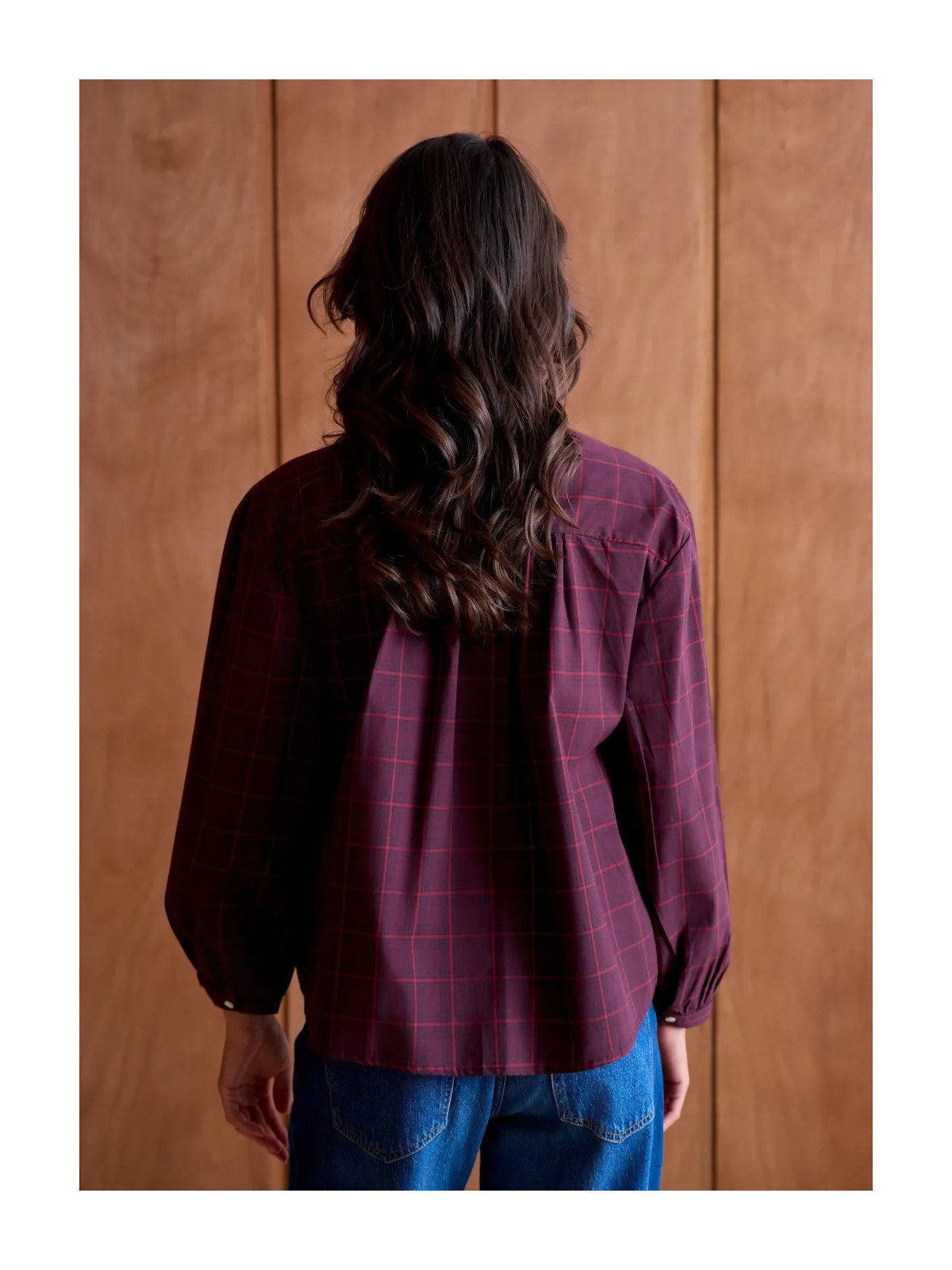 Women's loose-fitting blouse with a gathered neckline and appliqué details