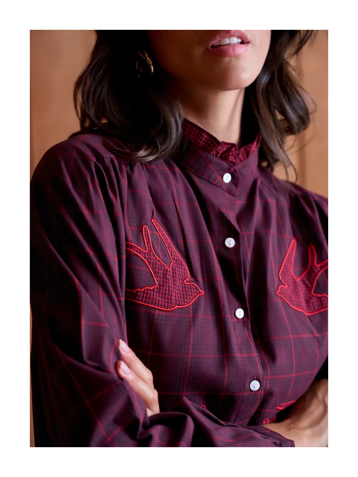 Women's loose-fitting blouse with a gathered neckline and appliqué details