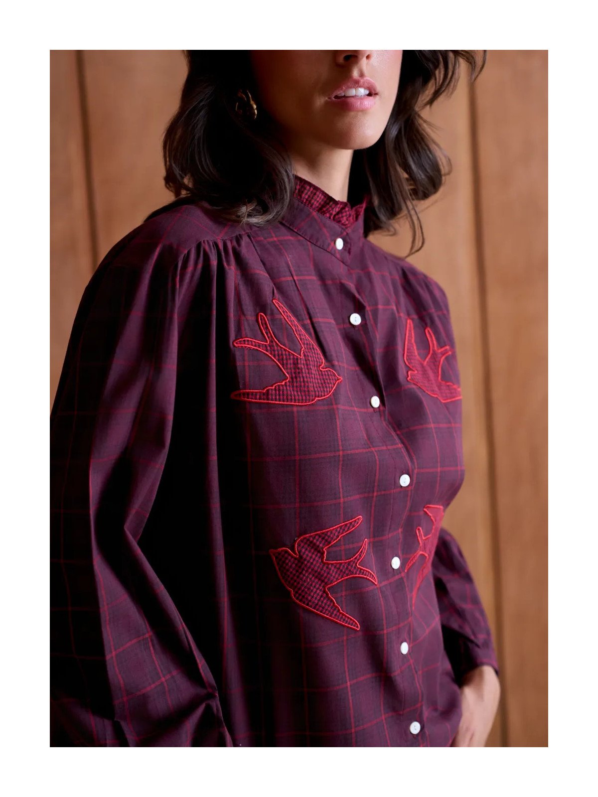 Women's loose-fitting blouse with a gathered neckline and appliqué details