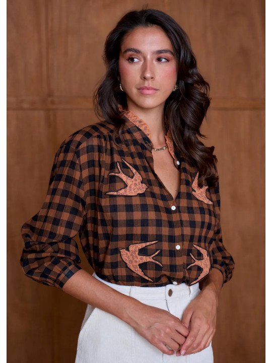 Women's loose-fitting blouse with a gathered neckline and appliqué details