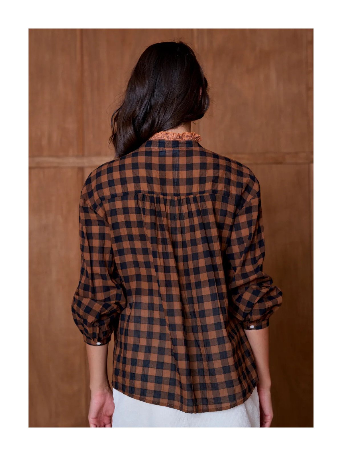 Women's loose-fitting blouse with a gathered neckline and appliqué details